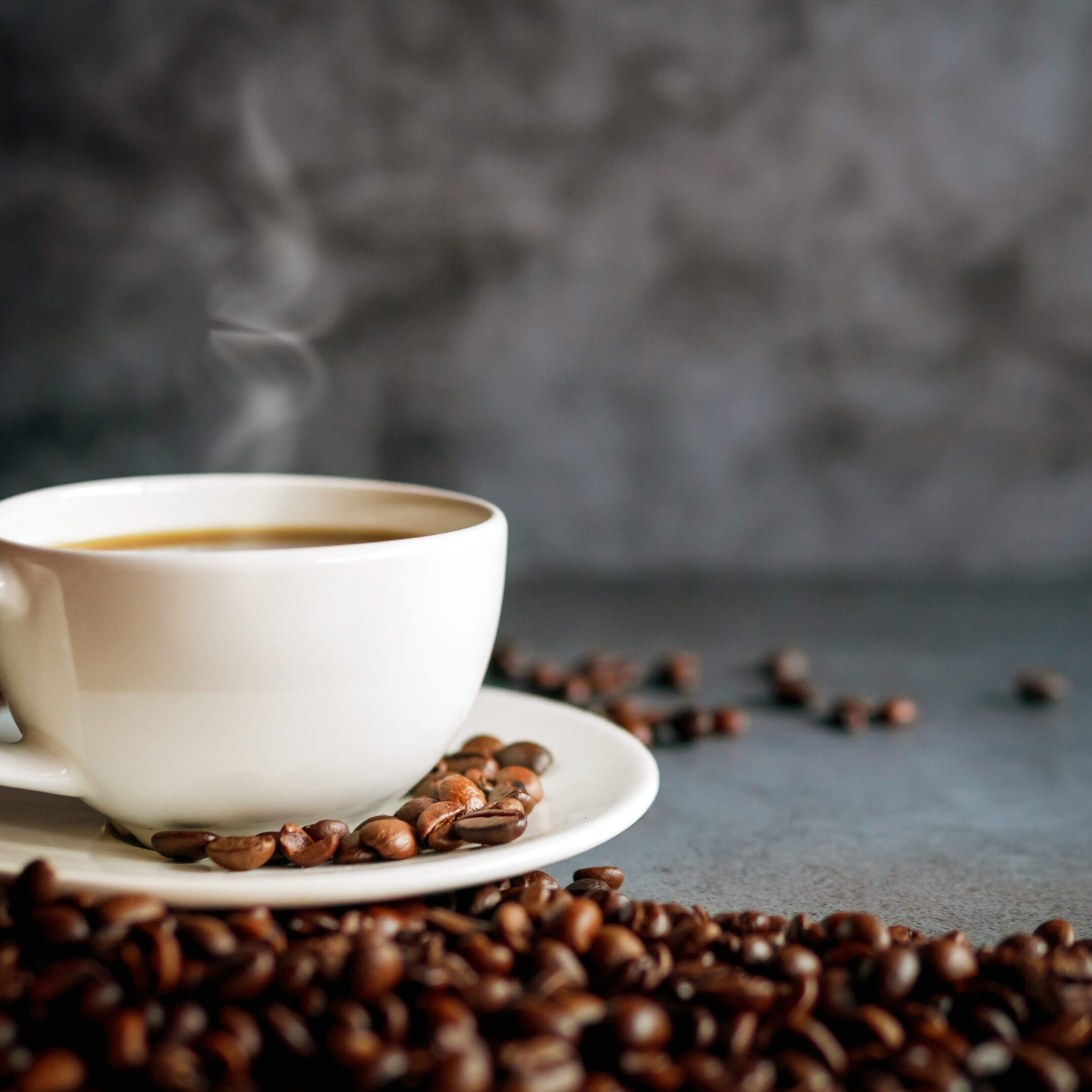 Coffee cup and coffee beans on  gray background, Black coffee cup aromatic